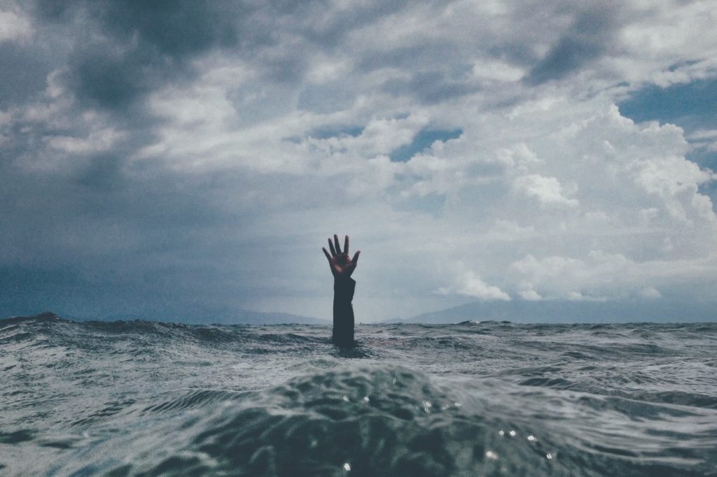 Person putting their hand of the water