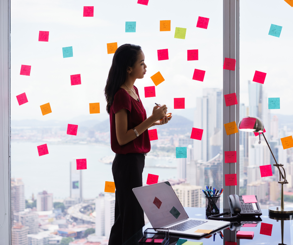 Person writing on sticky notes