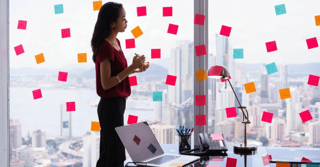 Person looking at window with post it notes